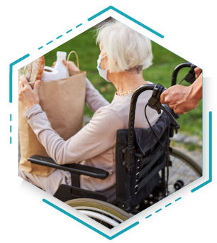 A woman in a wheelchair carries a shopping bag, showcasing her independence while out shopping.