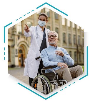 A healthcare professional discusses treatment with a patient in a wheelchair during a medical appointment.